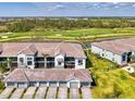 Beautiful waterfront home with a golf course view, featuring multiple garages and a screened-in balcony at 12470 Wellen Golf St # 208, Venice, FL 34293