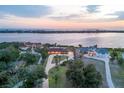Stunning aerial view of waterfront homes featuring a beautiful backyard and circular driveways at 1275 Bayshore Dr, Englewood, FL 34223