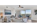 Bright living room with water views, neutral furniture, and access to a private balcony at 13113 Gasparilla Rd # A503, Placida, FL 33946