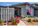 Inviting front entry with colorful flowers, painted entry door, and plenty of natural light at 148 Jose Gaspar Dr # 148, Englewood, FL 34223