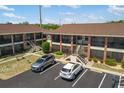 Two-story condo buildings with parking spaces and well-maintained landscaping at 1531 Placida Rd # 201, Englewood, FL 34223