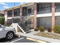 Two story building with stairs leading up to the units and green landscaping at 1531 Placida Rd # 201, Englewood, FL 34223