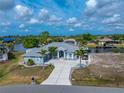 Charming single-story home featuring a well-manicured lawn and a circular driveway leading to the front entrance at 15674 Applewhite Cir, Port Charlotte, FL 33981