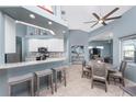 Bright, open kitchen with granite countertops, stainless steel appliances, and a breakfast bar overlooking the dining area at 15674 Applewhite Cir, Port Charlotte, FL 33981