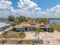 Beautiful view of a single story home with well kept lawn, blue exterior, and canal access at 158 Morgan Se Ln, Port Charlotte, FL 33952