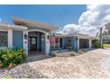 Attractive home with a landscaped front yard and a charming facade enhanced by the American flag and tasteful details at 158 Morgan Se Ln, Port Charlotte, FL 33952