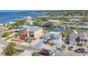 Wide aerial view of waterfront home, with mature landscaping and neighborhood features at 17 Southwind Dr, Englewood, FL 34223