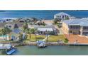 Waterfront home with mature palms, dock, and screened porch at 17 Southwind Dr, Englewood, FL 34223