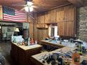 View of kitchen with wood paneling and cabinets at 1916 Myrtle Ave, Punta Gorda, FL 33950