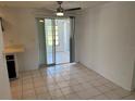 Bright dining area with a ceiling fan and sliding doors leading to a screened-in porch at 194 Garden Nw Ave, Port Charlotte, FL 33952