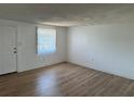A bright and airy living room featuring wood floors, neutral walls, and a window for natural light at 194 Garden Nw Ave, Port Charlotte, FL 33952