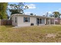 Quaint one-story home featuring blue shutters, fresh exterior paint, and a well-kept front lawn at 21070 Gertrude Ave, Port Charlotte, FL 33952