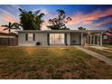 Lovely home with blue shutters, beautiful twilight skies, and a manicured lawn at 21070 Gertrude Ave, Port Charlotte, FL 33952