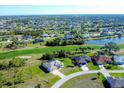 Breathtaking aerial view of homes surrounding a golf course and pond, showcasing an idyllic residential community at 27 Tee View Rd, Rotonda West, FL 33947