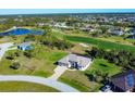 Gorgeous aerial shot of homes with golf course and water views, emphasizing the property's prime location in a tranquil setting at 27 Tee View Rd, Rotonda West, FL 33947