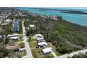 Aerial view of property with a blue truck, surrounded by lush trees and serene waterfront at 2906 Waterside Dr, Englewood, FL 34224