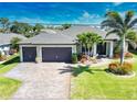 Aerial view of home showcasing its two-car garage, landscaping, and well manicured lawn at 35 Medalist Rd, Rotonda West, FL 33947