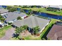 Aerial view of home with lush landscaping, a spacious backyard, and a waterfront view at 35 Medalist Rd, Rotonda West, FL 33947