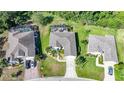 Aerial view of the property, surrounded by lush greenery, and close proximity to neighboring houses at 4004 Landor Ct, Venice, FL 34293