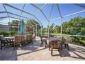 Large screened-in patio with outdoor furniture, creating an inviting space for relaxation and dining at 4004 Landor Ct, Venice, FL 34293
