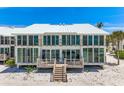 Beautifully designed beach house featuring a white roof, spacious balconies, and easy beach access at 5000 Gasparilla Rd # 23A, Boca Grande, FL 33921