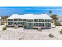 Stunning beachfront home boasting modern architecture, with a crisp white exterior and multiple balconies at 5000 Gasparilla Rd # 23A, Boca Grande, FL 33921