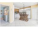 Bright kitchen featuring white cabinets, appliances, and a unique center island with a woven base at 5000 Gasparilla Rd # 23A, Boca Grande, FL 33921