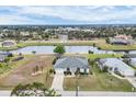 Scenic aerial view of a beautiful house, showcasing water access, lush landscaping and neighboring homes at 642 Boundary Blvd, Rotonda West, FL 33947
