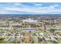 Scenic aerial view of a community with waterfront properties, lakes, and picturesque landscaping at 642 Boundary Blvd, Rotonda West, FL 33947