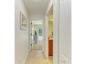 Hallway with tile flooring offering a view of the Primary bedroom at 68 Long Meadow Ln, Rotonda West, FL 33947