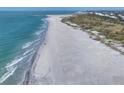 Expansive beach view showcasing the beautiful coastline with gentle waves rolling onto the shore at 7470 Palm Island Dr # 2813, Placida, FL 33946