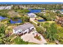 An aerial view of the property with lush trees, waterfront access, and neighborhood at 760 S Oxford Dr, Englewood, FL 34223