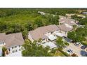 Wide aerial view of residential neighborhood with mature trees and well-kept townhomes at 821 Montrose Dr # 201, Venice, FL 34293