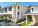 Charming two-story townhome with blue shutters, covered parking, and manicured landscaping at 821 Montrose Dr # 201, Venice, FL 34293