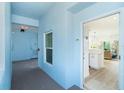 Hallway leading to unit 205, showcasing the door to the apartment and view of the interior at 8413 Placida Rd # 205, Placida, FL 33946