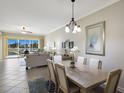 Dining area with seating for six and large sliding door overlooking the lanai at 8500 Amberjack Cir # 102, Englewood, FL 34224