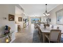 Bright and airy living room and dining area with sliding doors to a balcony and neutral decor at 8500 Amberjack Cir # 102, Englewood, FL 34224