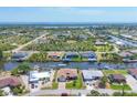 Stunning aerial view of a waterfront community with canal access and lush greenery at 9574 Arsipe Cir, Port Charlotte, FL 33981