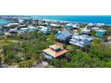 Expansive aerial view of colorful coastal homes, showcasing a vibrant community near the ocean at 9580 Almirate Ct, Placida, FL 33946