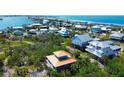 Picturesque aerial view of coastal homes near the ocean, showcasing a vibrant community at 9580 Almirate Ct, Placida, FL 33946