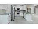 Modern kitchen featuring white cabinets, stainless steel appliances, and durable countertops at 10164 Stonecrop Ave, Englewood, FL 34224