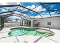 Relaxing screened-in pool with ample patio space, ideal for outdoor lounging and entertaining friends at 10164 Stonecrop Ave, Englewood, FL 34224