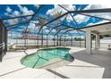 Inviting screened-in pool area perfect for relaxation and enjoyment, surrounded by a spacious patio at 10164 Stonecrop Ave, Englewood, FL 34224