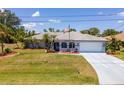 Inviting single-story home with a well-manicured lawn and charming curb appeal at 10182 Charlemont Ave, Englewood, FL 34224