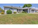 Charming single-story home with a well-manicured lawn and attached garage at 1035 Riggs St, Port Charlotte, FL 33952