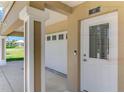 Exterior image featuring the front door and two-car garage on a well-maintained property at 10411 Coral Landings Ln # 85, Placida, FL 33946