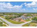 Aerial view showcases the home's location within a tranquil, tree-lined neighborhood with verdant surroundings at 11008 Waterford Ave, Englewood, FL 34224