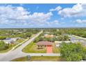 Wide aerial shot displaying the house nestled in a calm neighborhood surrounded by lush greenery at 11008 Waterford Ave, Englewood, FL 34224