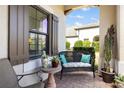 Cozy front patio featuring outdoor seating and a view of the charming neighborhood at 11125 Mcdermott Ct, Englewood, FL 34223