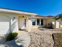 Close up of front door, featuring a covered entryway and tiled walkway at 1155 Osceola Blvd, Englewood, FL 34223